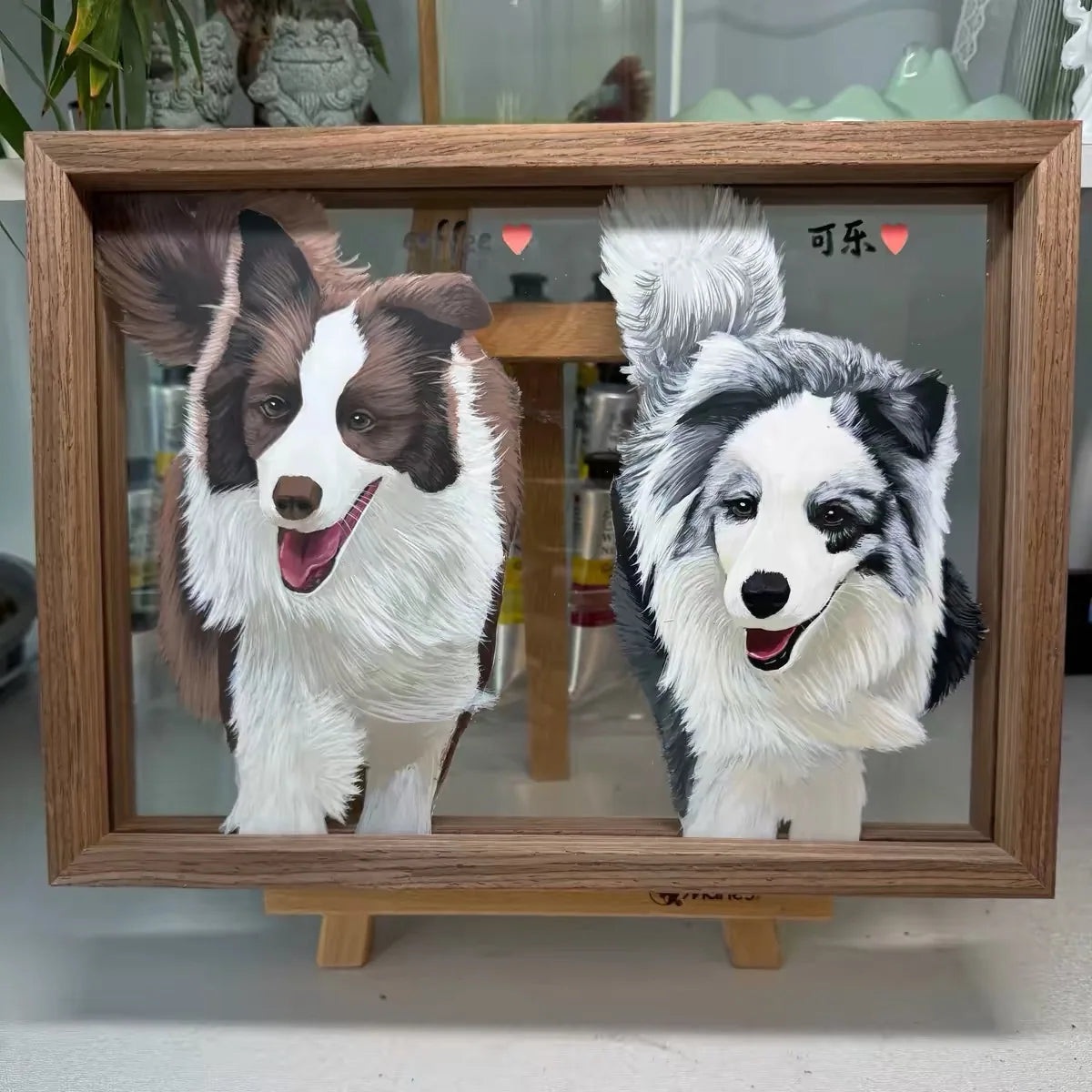 Two black-and-white collies painted together in a landscape frame.