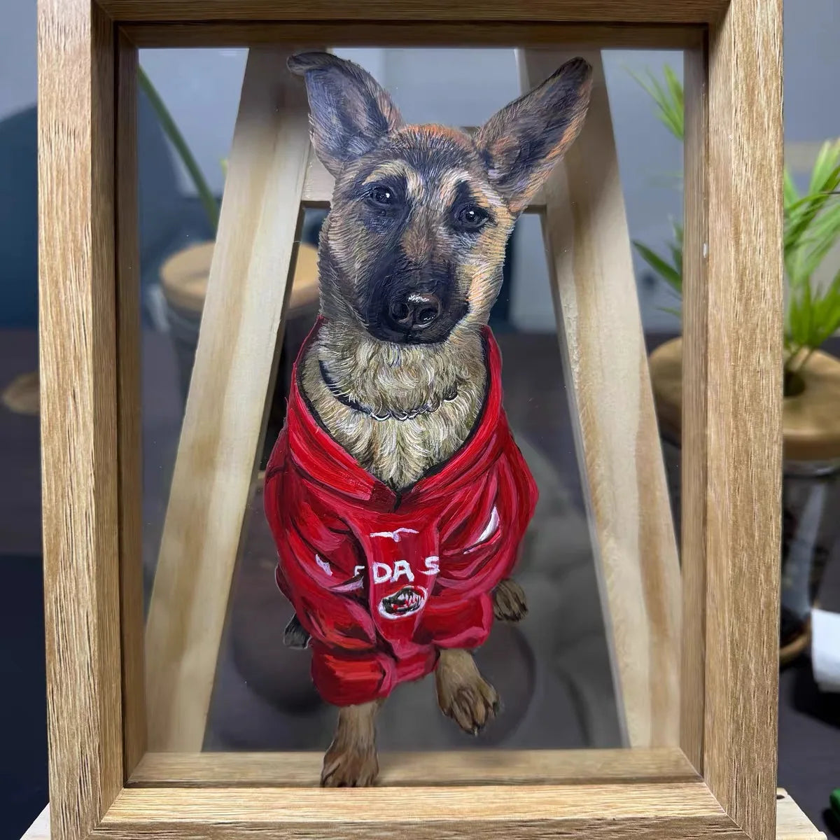 Shepherd portrait in red jacket on studio easel.