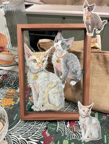 Two cats painted together in a tall wooden frame.