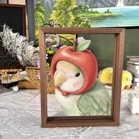 A small bird portrait wearing a red apple-shaped hood.