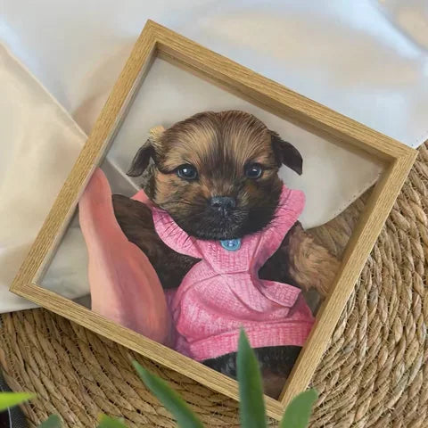 A small brown dog painted in a pink outfit.