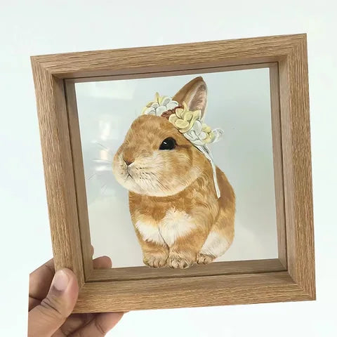 Handheld rabbit frame against plain background.