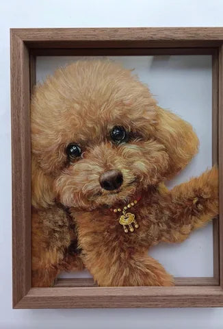 Close view of brown curly dog portrait in wood frame over pale floor/surface.